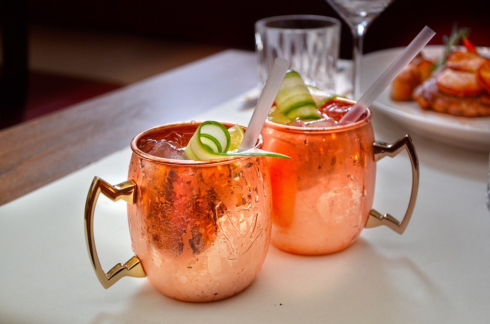Going out in Leipzig Two cocktails in bronze cups with ice and cucumber